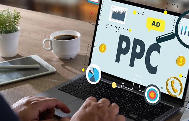 Person typing on a laptop showing a Pay-Per-Click PPC marketing dashboard beside coffee.