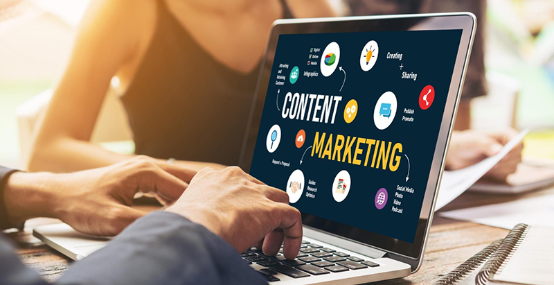Content marketing services dashboard displayed on a laptop with digital marketing icons.